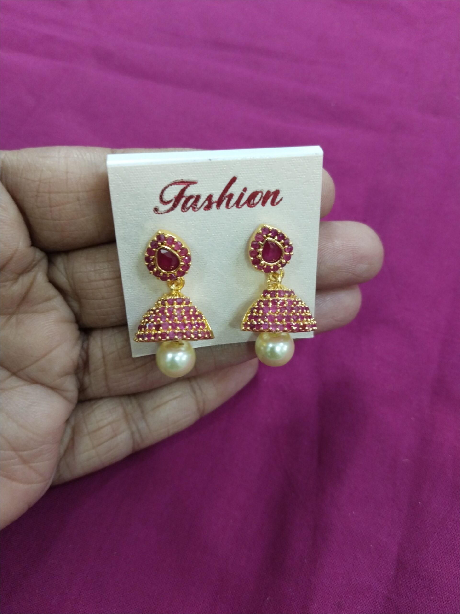 Gold Plated Jhumka Earrings with Pink Stones & Pearl Beads