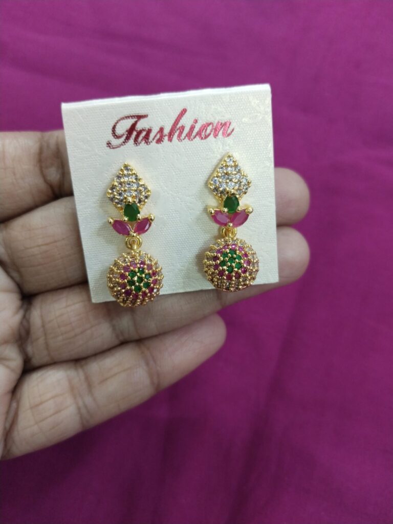 Gold jhumka earrings with pink and green stones, CZ crystals, and pearl drop.